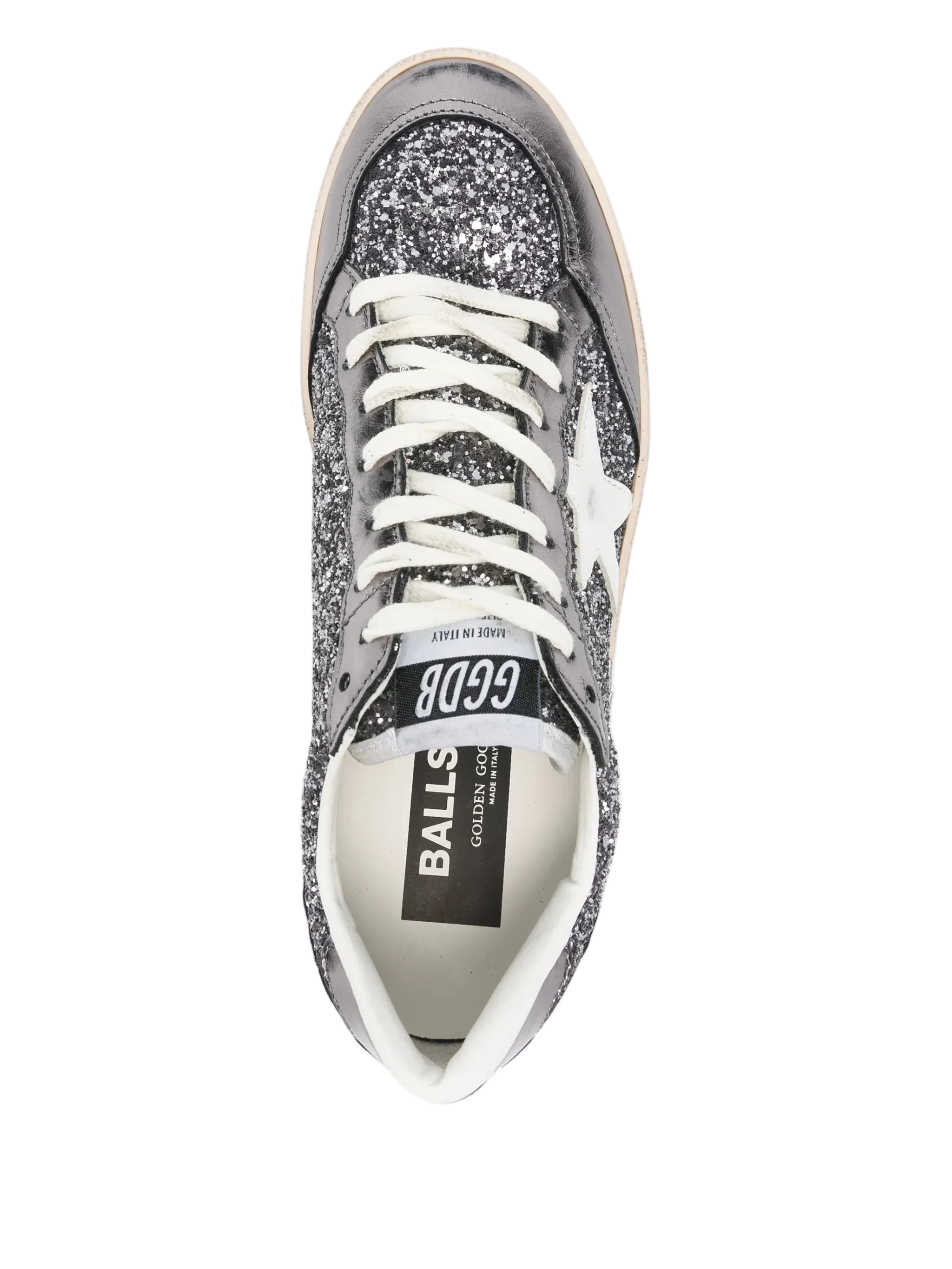 Silver glitter sneaker with white laces on a white background