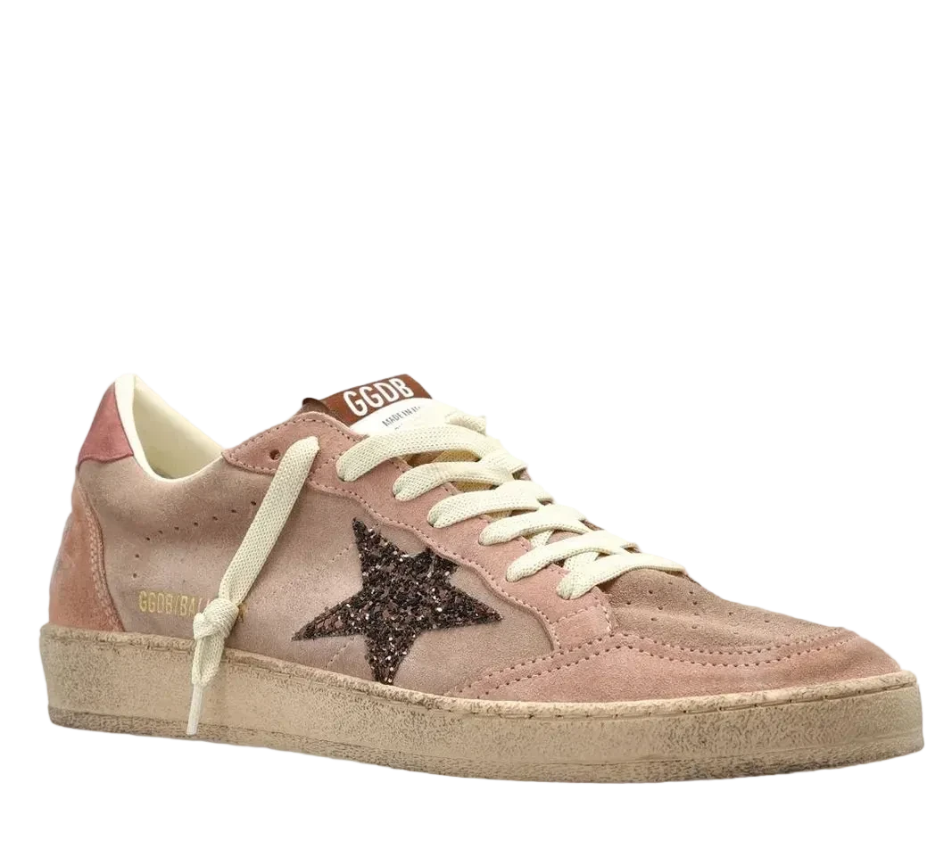 Pink sneaker with a black star on a white background