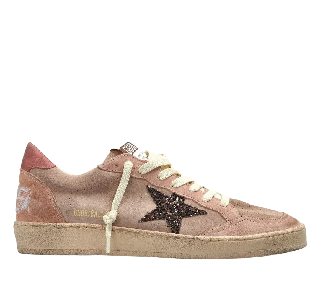 Pink sneaker with a star detail on a white background